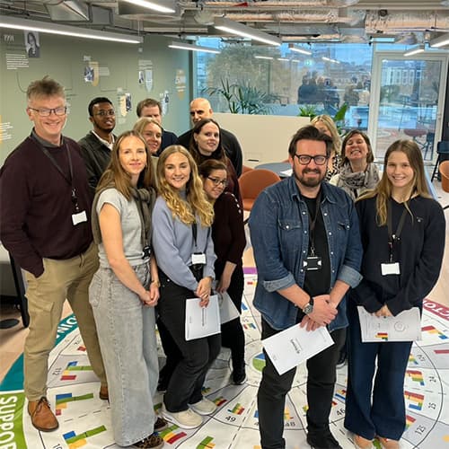 Group standing on Insights Discovery mat