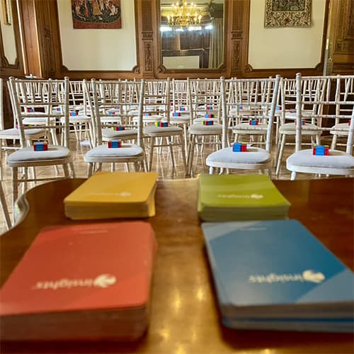 Insights Discovery workshop cards with white chairs in the background.